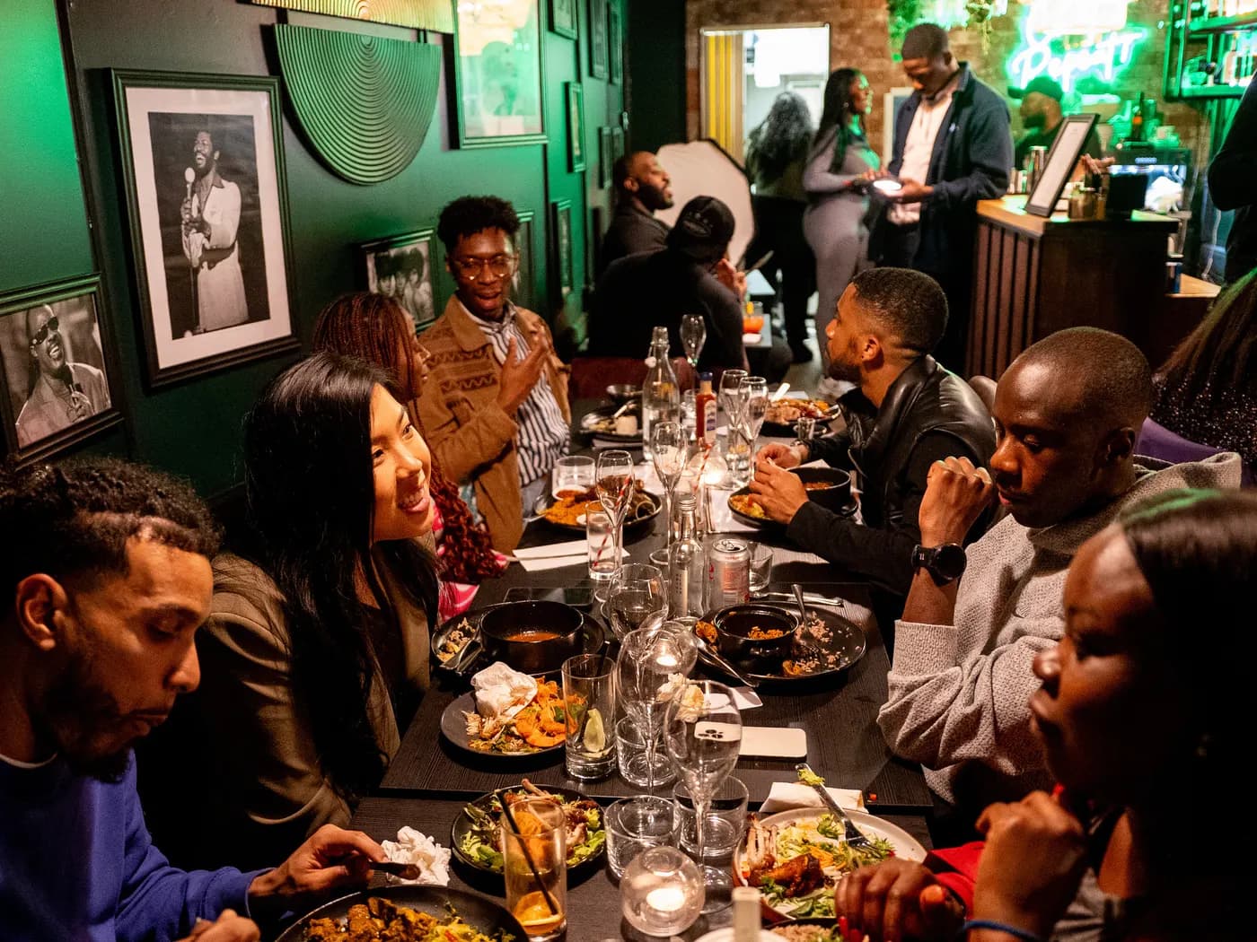A long table mid-conversation at a Joyful dinner